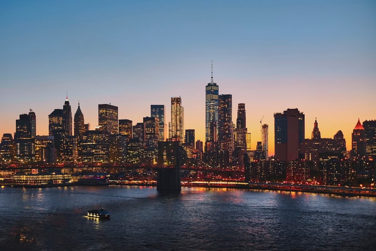 Lower Manhattan skyline at dusk seen across the East River